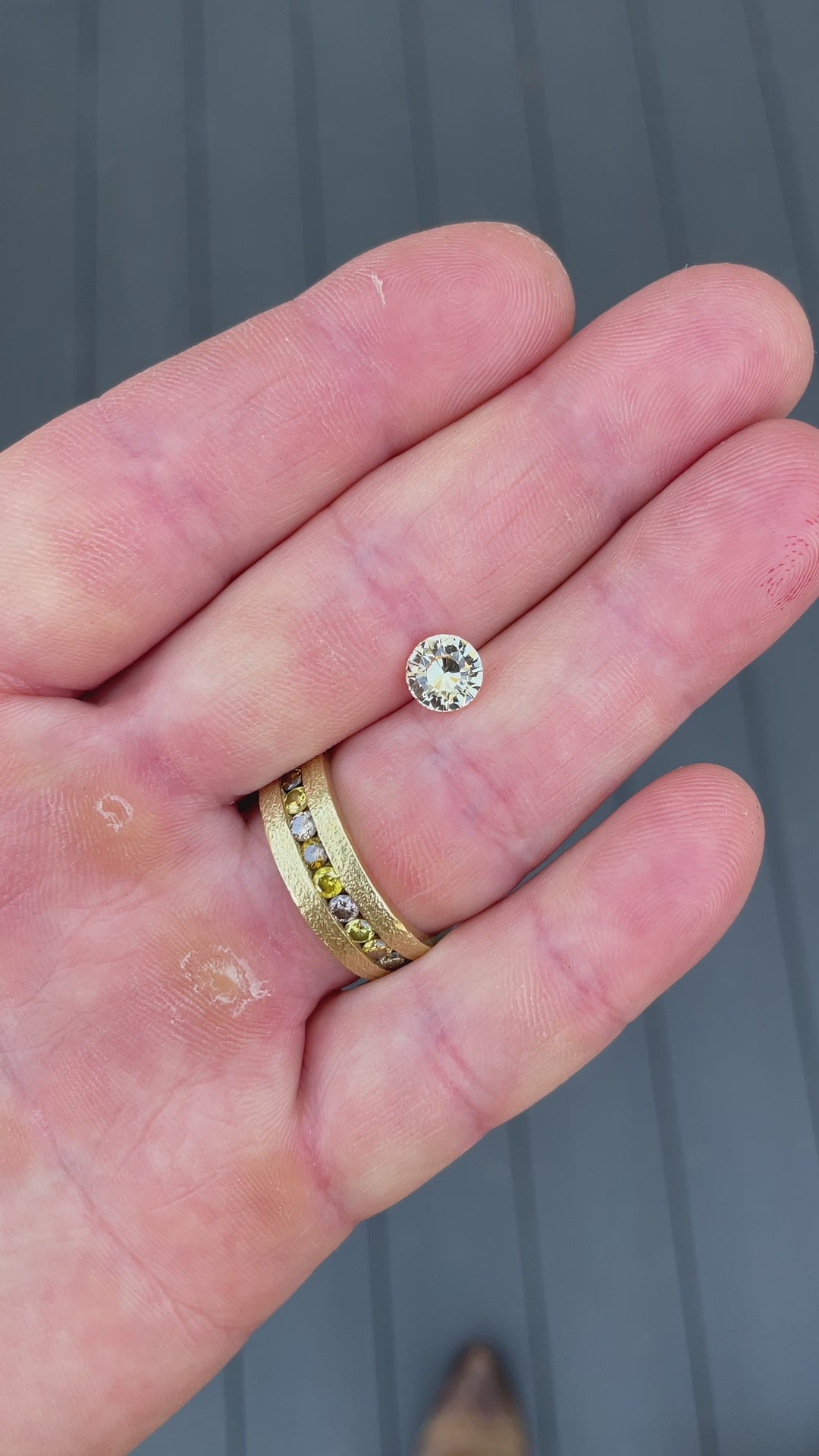 Peach yellow sapphire weighing 1.59 carats, filmed in motion to capture the stone’s natural brilliance and unheated clarity from all angles.