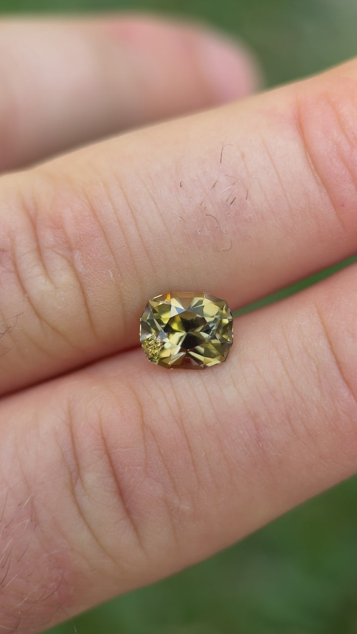 Close-up of golden yellow Tanzanite reflecting light in custom cushion cut – 2.60 carats, unheated Tanzanian gemstone