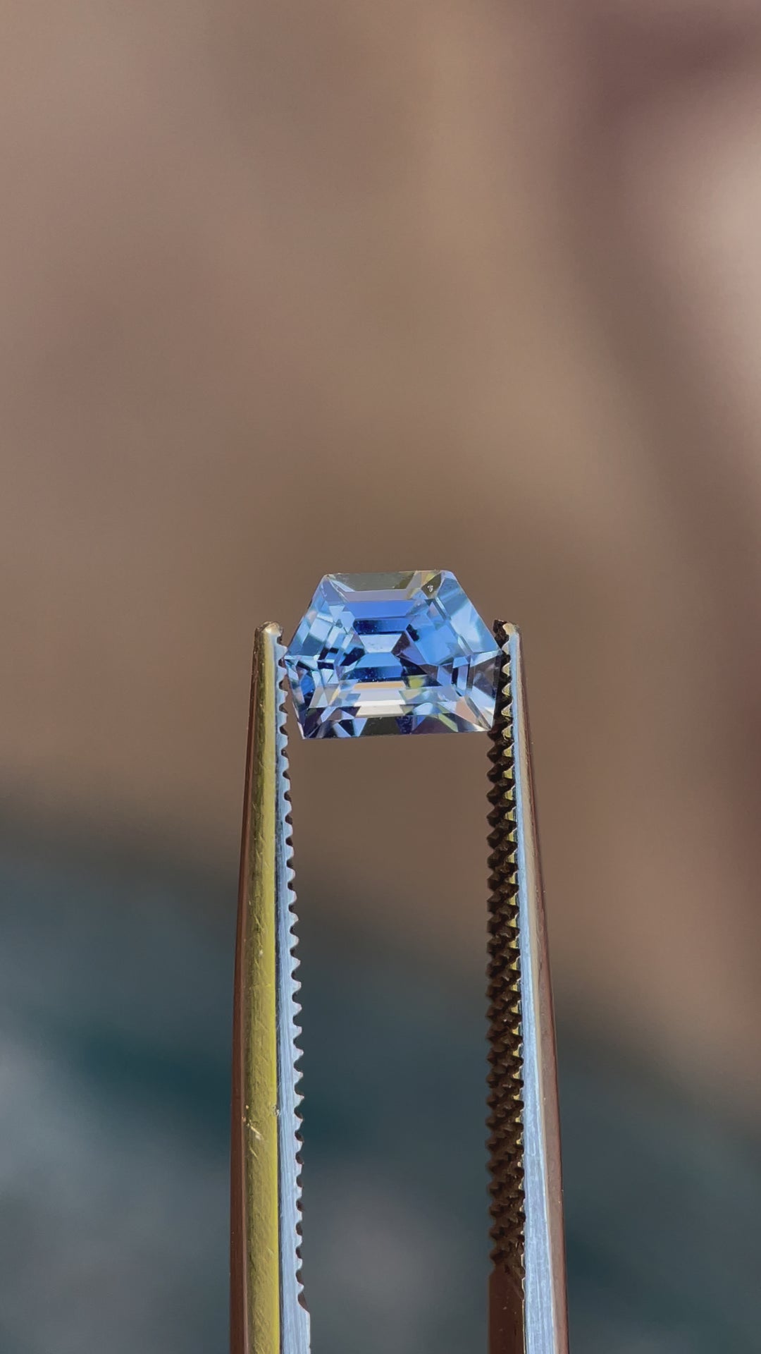 Video showcasing the captivating cornflower blue color and precise geometric step cut of a 1.42 carat No Heat Sapphire from Sri Lanka, displayed against a soft, neutral background to highlight its pristine clarity and vibrant hue.