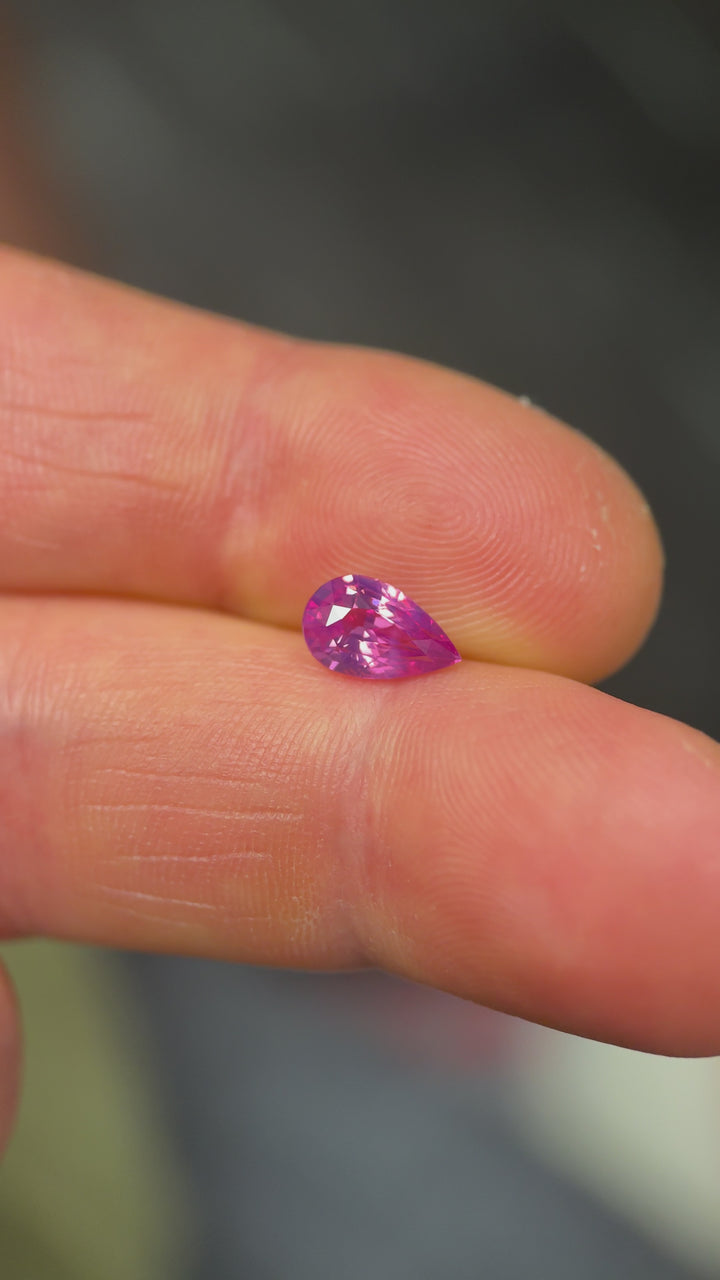 Rotating 1.57 carat pink kite sapphire from Sri Lanka under natural light, displaying heated clarity and sparkle.