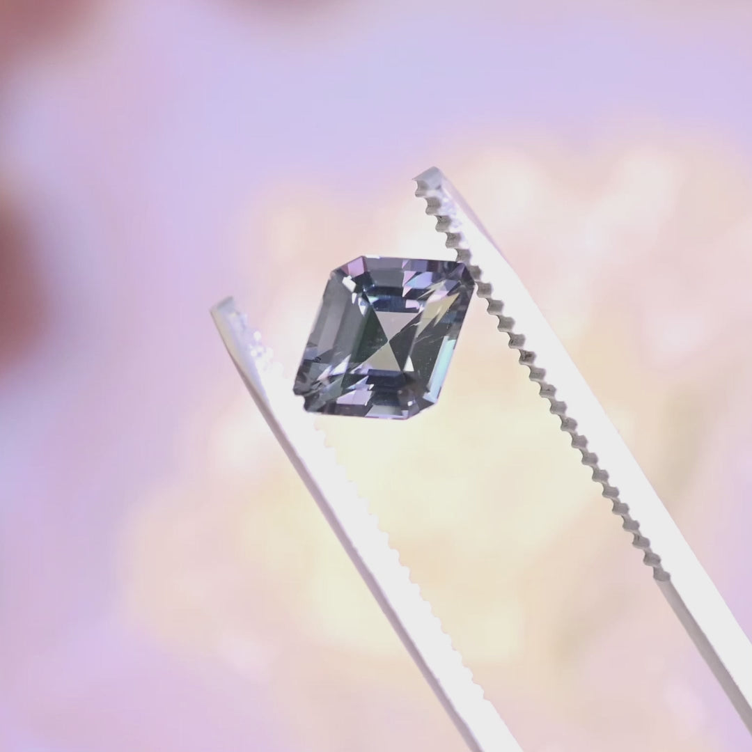 1.52 carat custom rhombus step cut Tanzanite rotating under light showing teal blue green purple color play and sparkle from Merelani Hills Tanzania