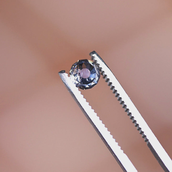 Loose fancy light brown Mughal cut champagne diamond from South Africa rotating in tweezers, showcasing its character, sparkle, and antique-style cut.