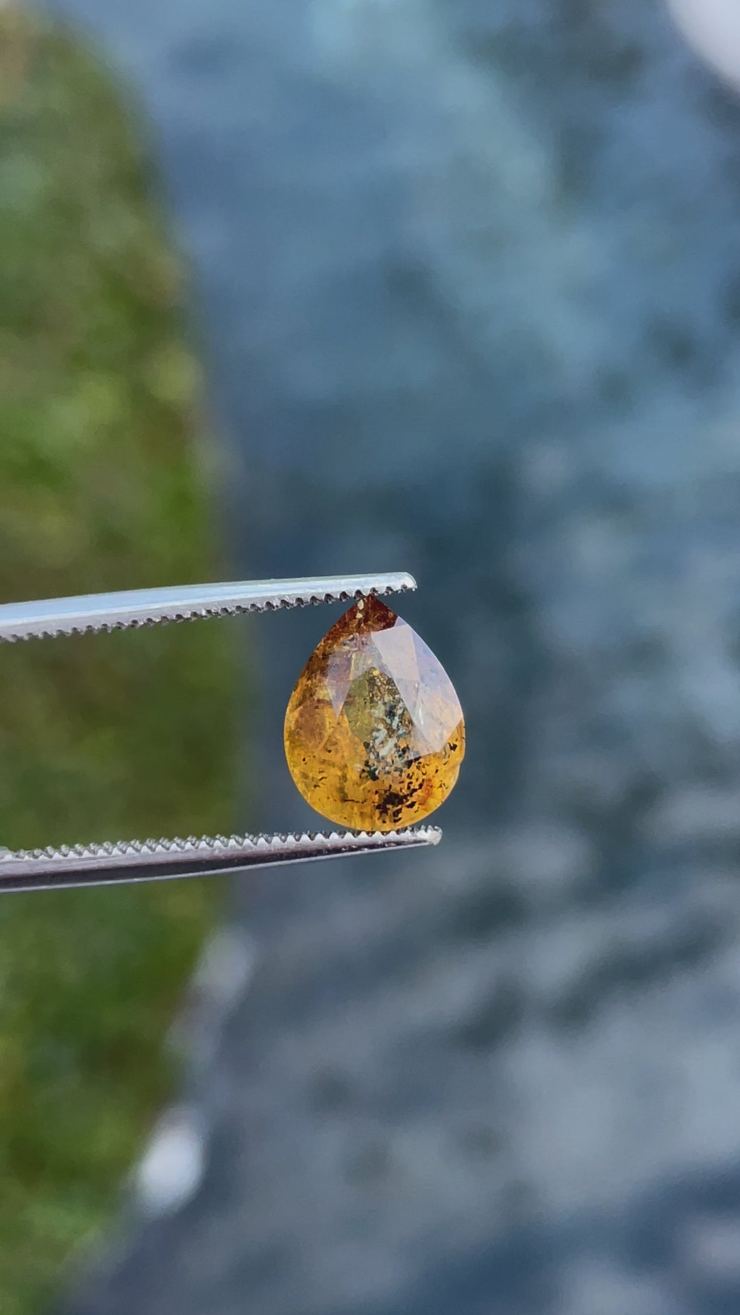 A video demonstrating the brilliance and unique inclusions of a 3.03-carat yellow-orange sapphire, highlighting its pear-modified cut." Title: "Close-up Video of 3.03-carat Sapphire