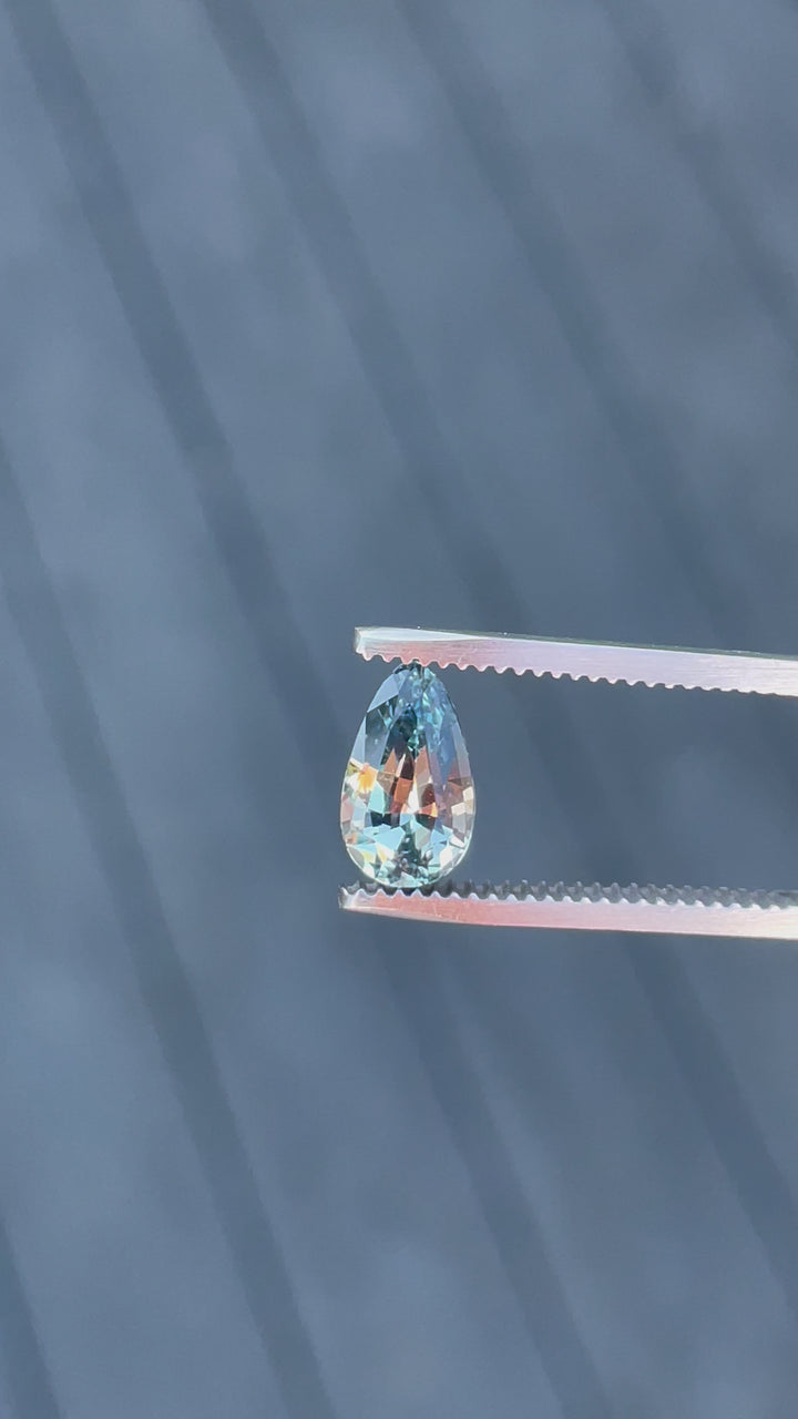 Video capture of a 2.00-carat seafoam and lime green sapphire in a custom teardrop shape, illustrating its stunning clarity and vibrant color, sourced from Sri Lanka without any treatment.
