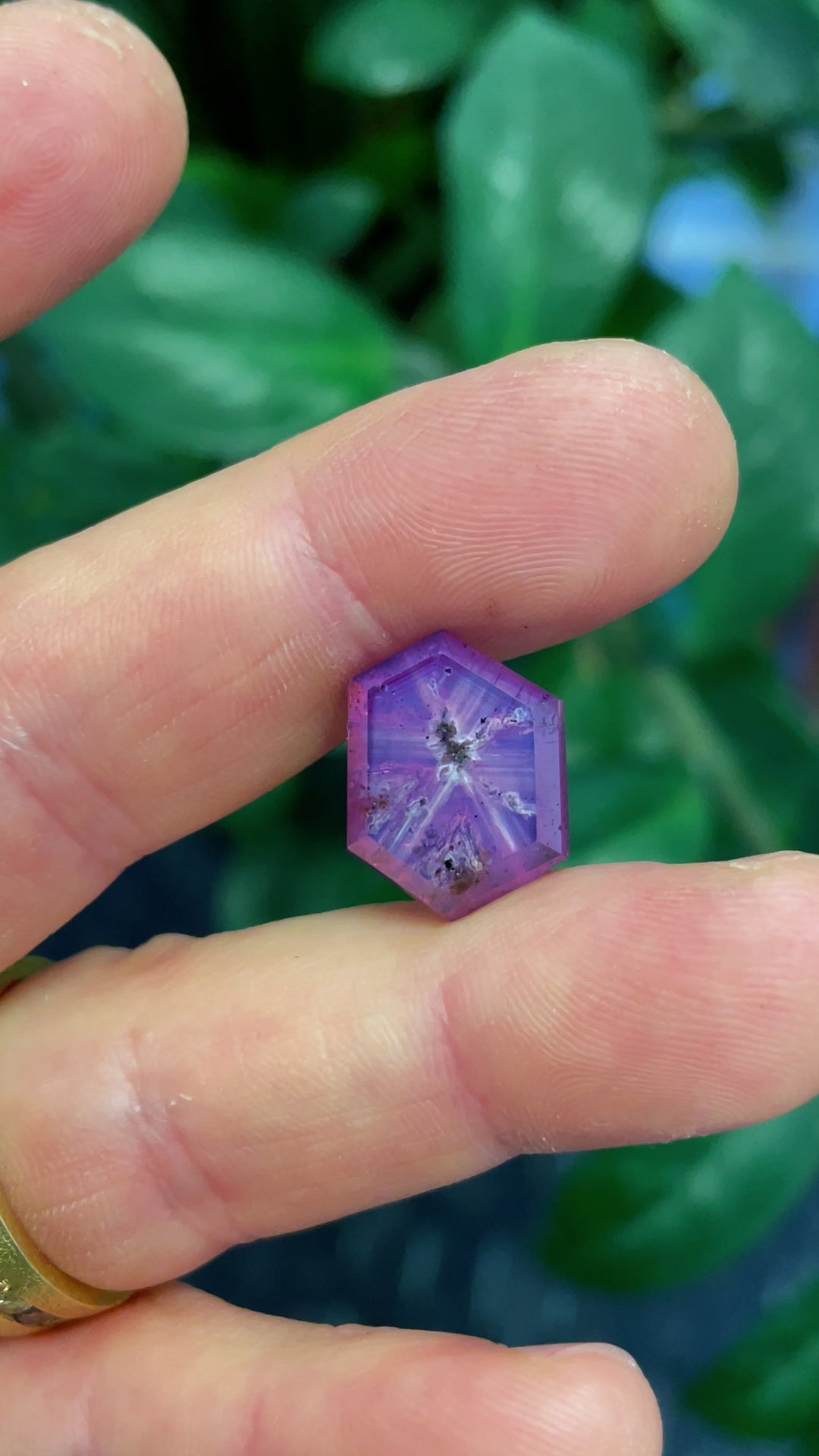 A close-up video of a 19.62-carat untreated sapphire from Afghanistan, revealing its breathtaking pink and purple hues and intricate cut from multiple angles.