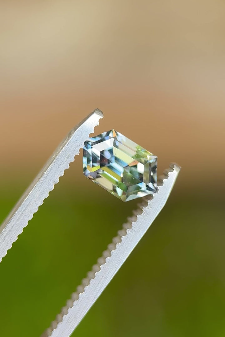 360-degree tweezers view of 1.52ct Tanzanite from Merelani Hills – step cut hexagon with vibrant mermaid hues