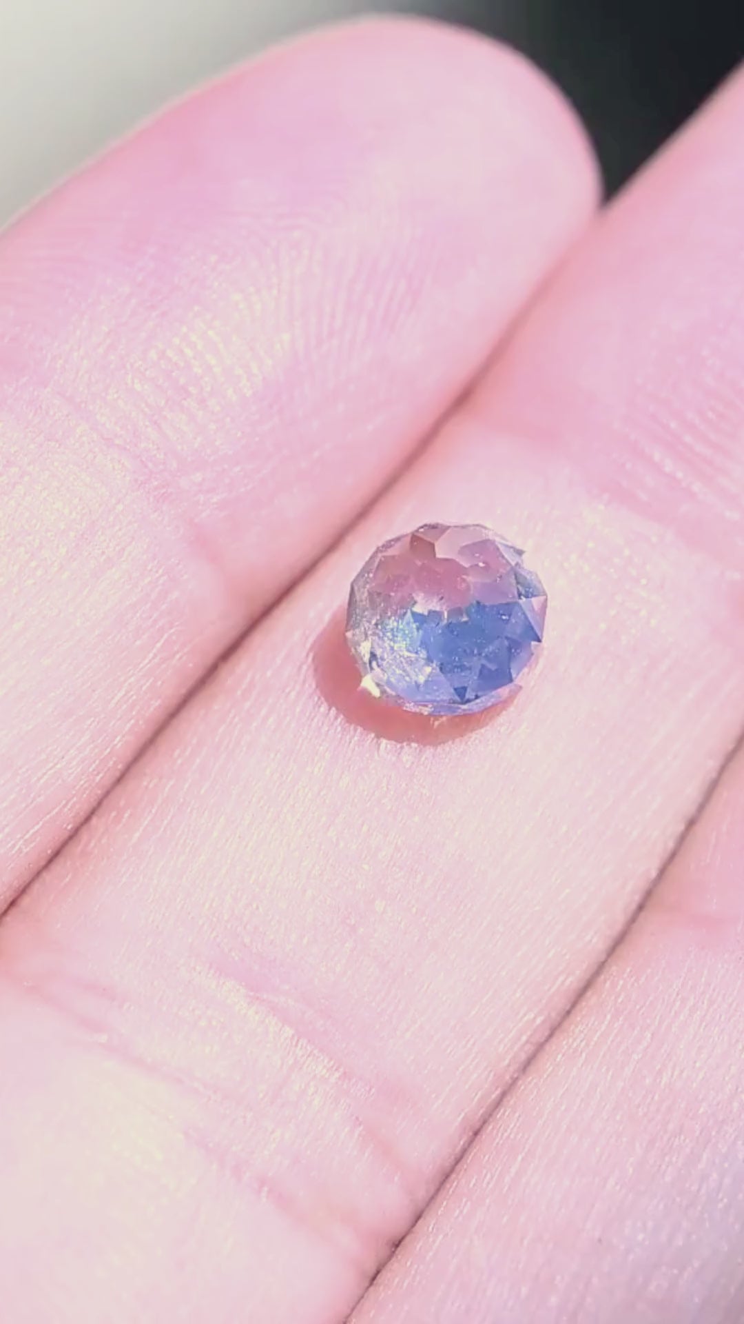 1.68 carat Mughal cut diamond shown on a hand in motion, revealing its scale, domed form and broad flashes of reflected light.