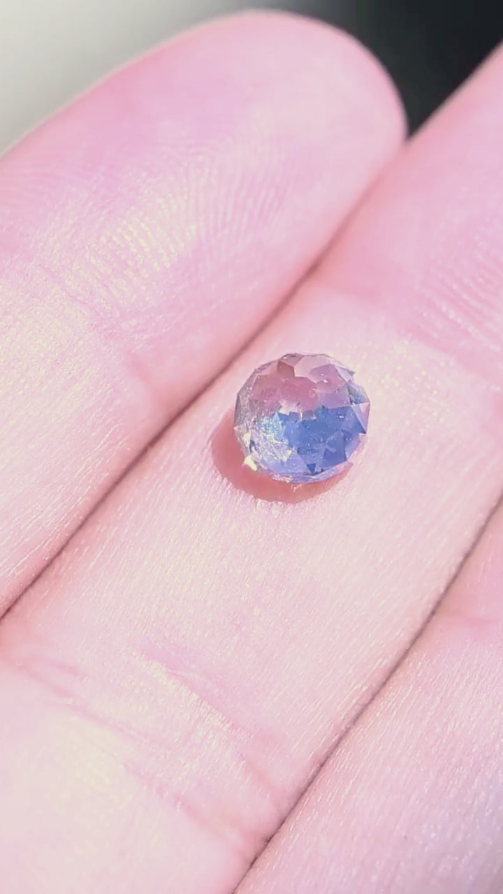 1.68 carat Mughal cut diamond shown on a hand in motion, revealing its scale, domed form and broad flashes of reflected light.