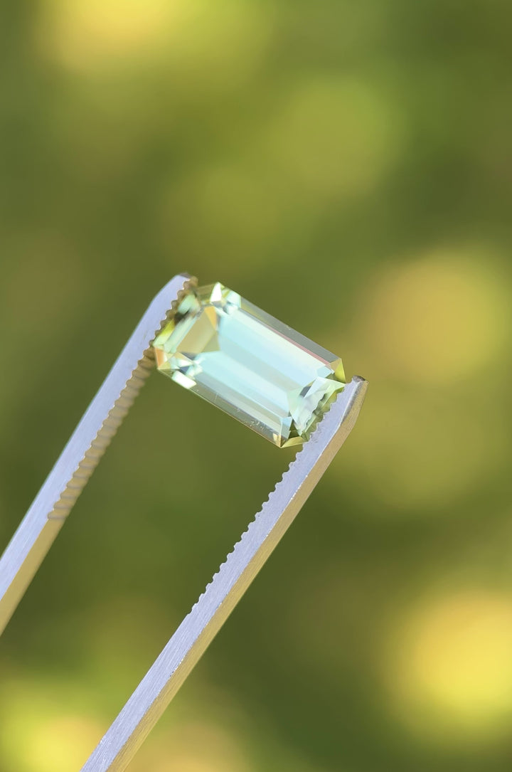 Rotating video of 4.51 carat mint green tourmaline from Congo, Africa, showing brilliance through precision emerald cut facets and untreated natural clarity under daylight.