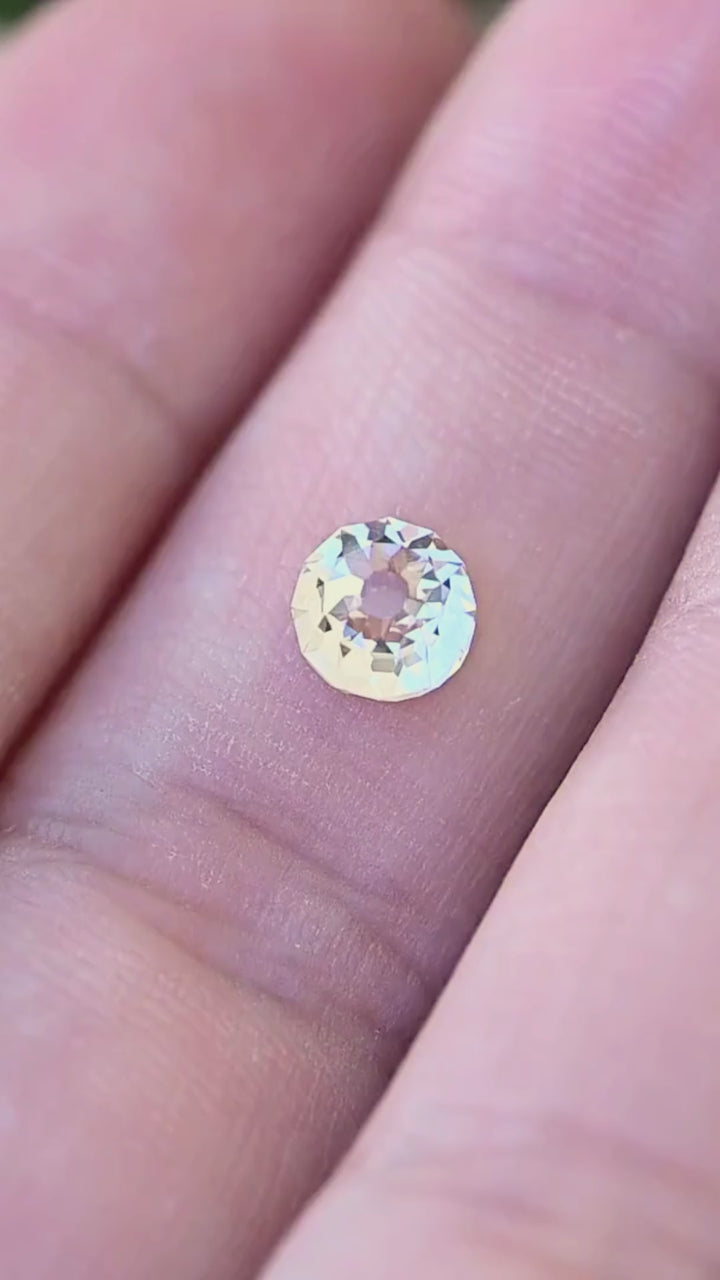 1.09 carat round Mughal cut diamond shown in motion on a hand, revealing its scale and shifting white, silvery blue and softly warm reflections.