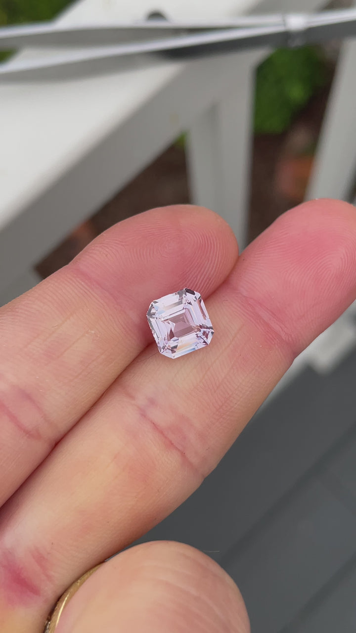 3.02CT pink-purple square emerald cut sapphire from Madagascar turning in natural light, revealing its untreated pastel hues and step-cut sparkle.