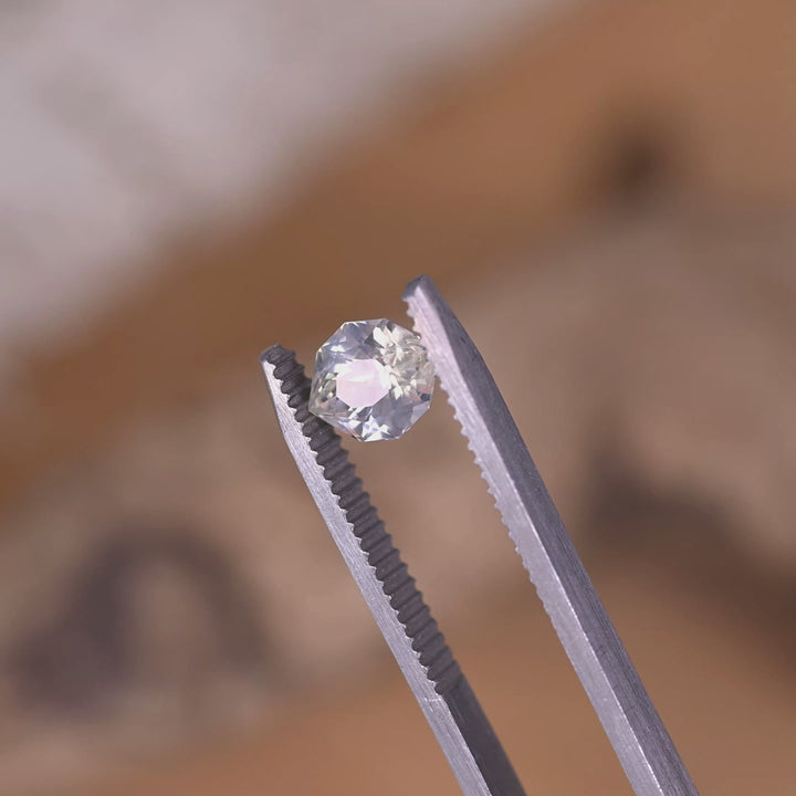 Rotating loose pastel green yellow sapphire from Ratnapura Sri Lanka showing the brilliance and color shift of the custom geometric marquise cut.