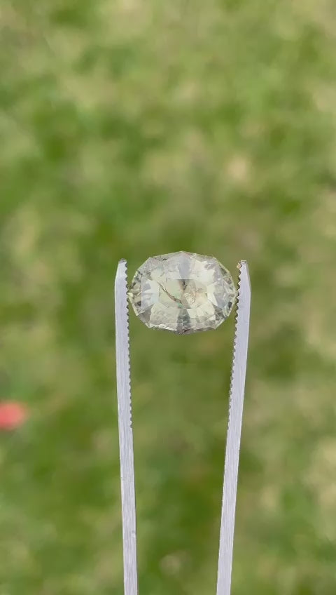 Presentation of a 7.14-carat color-changing sapphire, focusing on its cut, natural properties, and the distinctive color shift, demonstrated with a background that enhances its visual appeal.