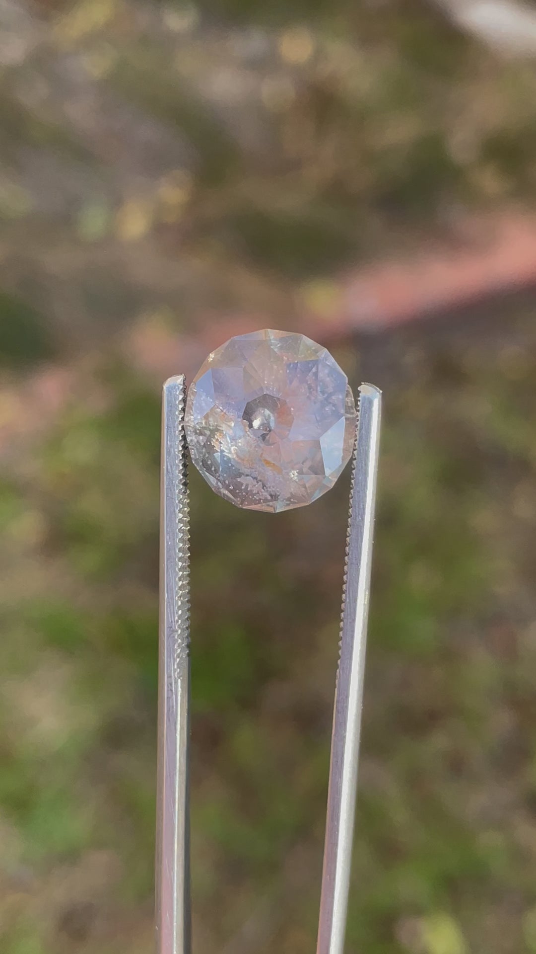 A detailed video highlighting the intricate facets of a modified round Portuguese-cut sapphire weighing 6.38 carats. Its natural hues of green, gray, and yellow are beautifully displayed.