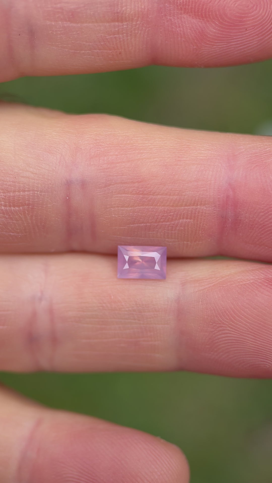Natural lighting video of untreated pink sapphire, demonstrating its opalescent quality and step-cut brilliance from multiple angles.