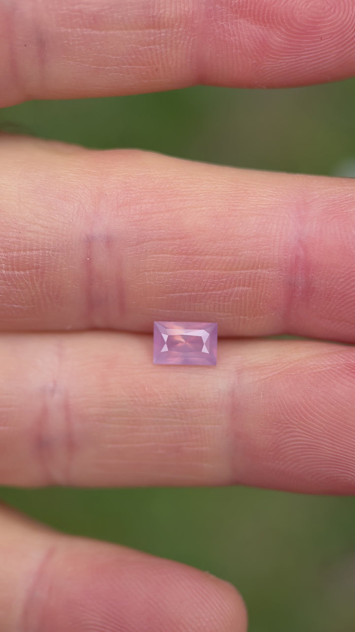 Natural lighting video of untreated pink sapphire, demonstrating its opalescent quality and step-cut brilliance from multiple angles.