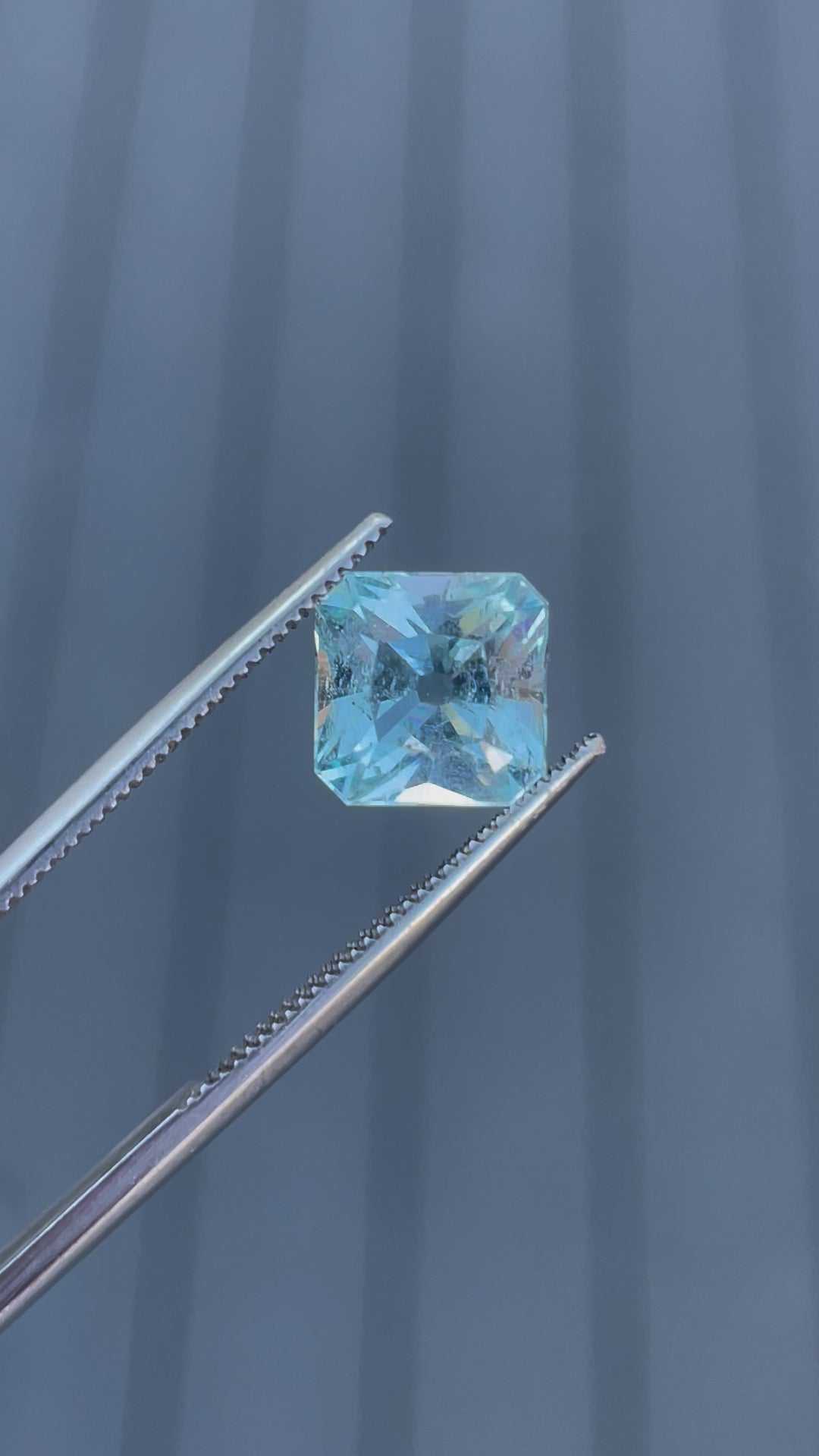 A detailed video showcasing a 2.87-carat aquamarine gemstone from multiple angles, emphasizing its unique antique cushion cut and seafoam blue hues.