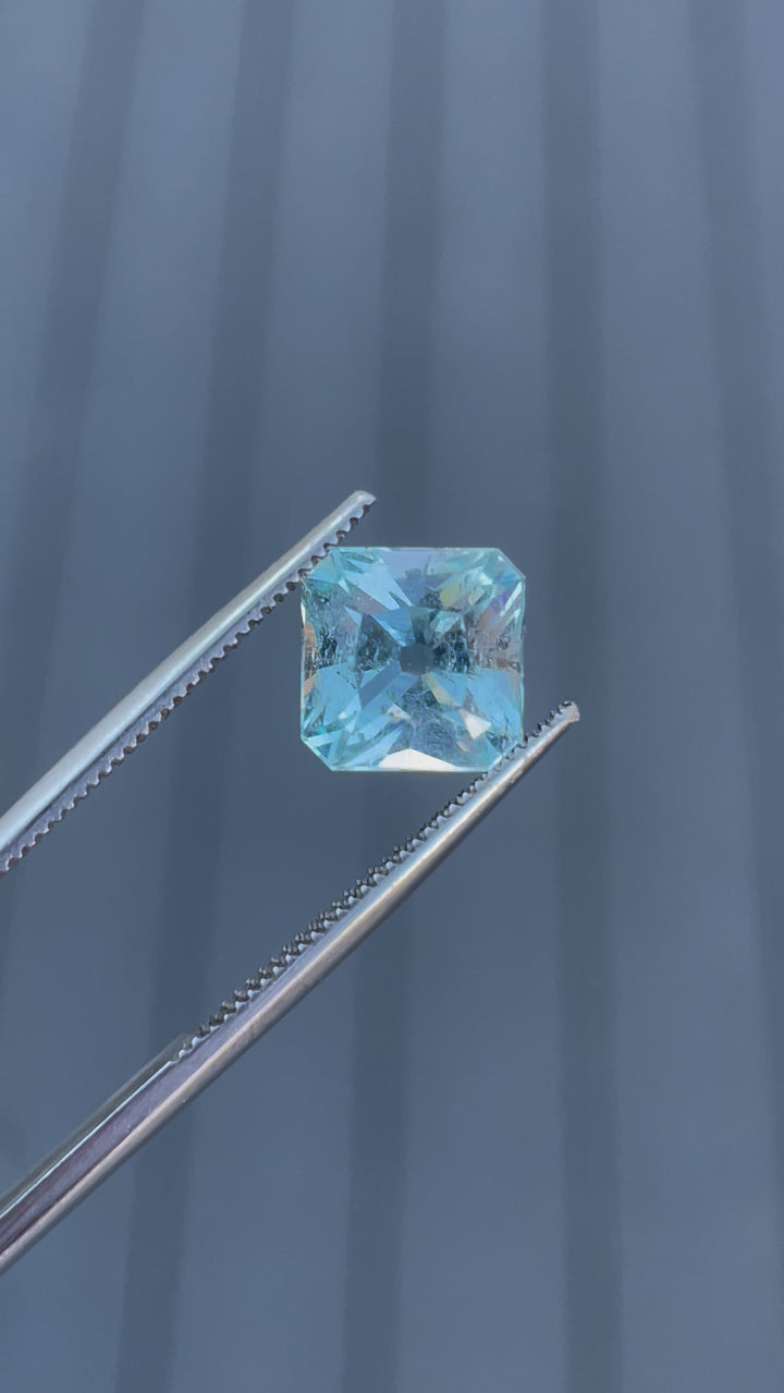 A detailed video showcasing a 2.87-carat aquamarine gemstone from multiple angles, emphasizing its unique antique cushion cut and seafoam blue hues.