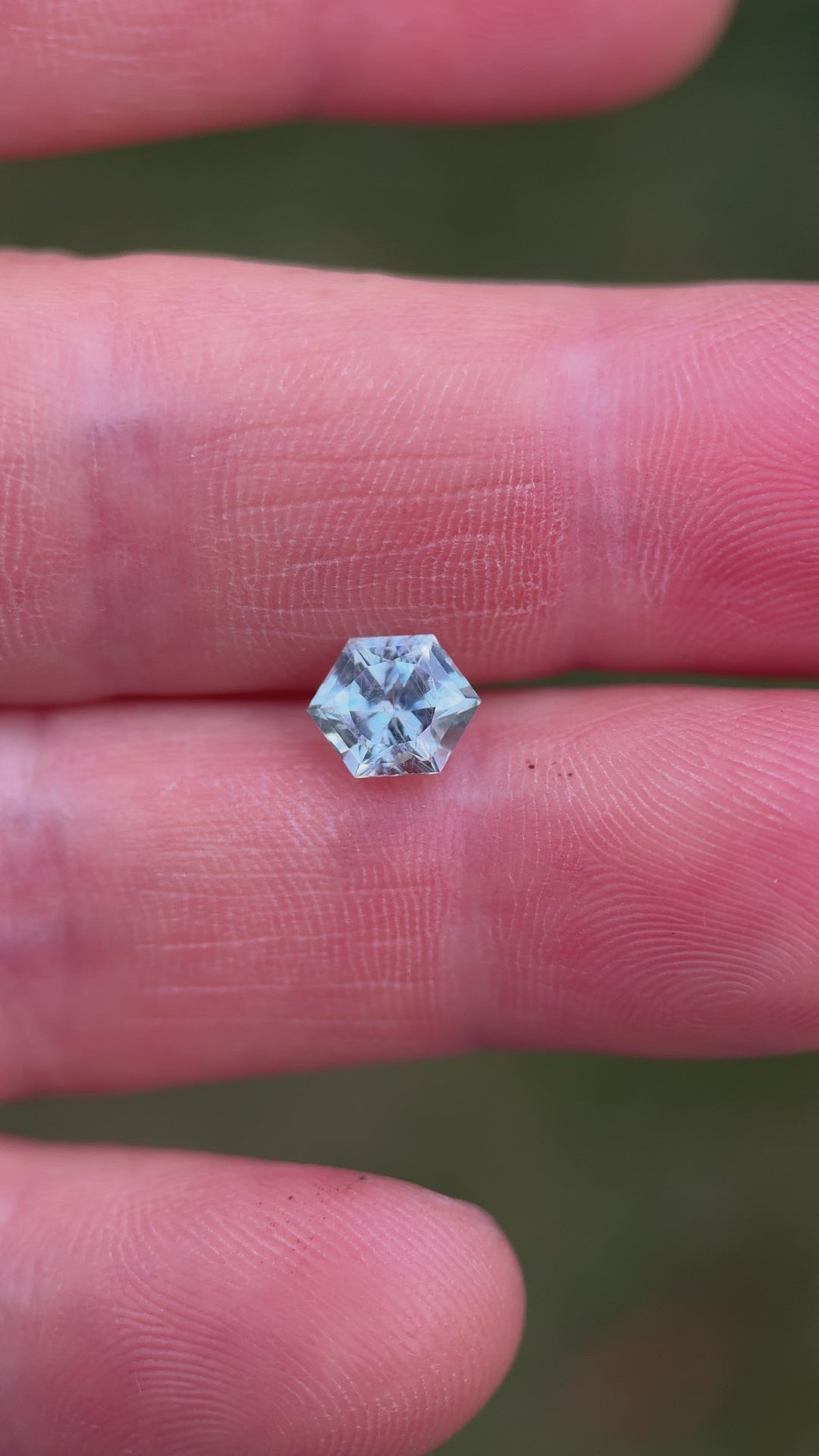 Close-up video of hexagon-cut Montana sapphire revealing untreated brilliance and geometric detail