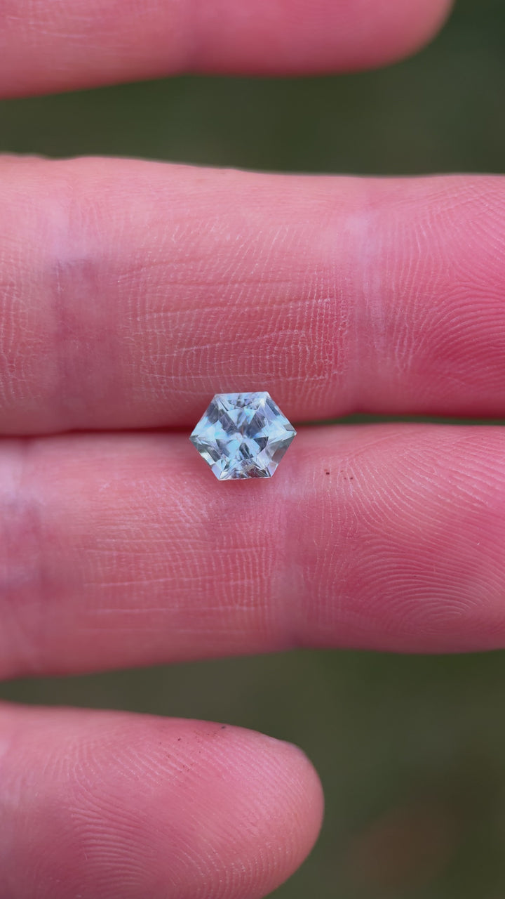 Close-up video of hexagon-cut Montana sapphire revealing untreated brilliance and geometric detail