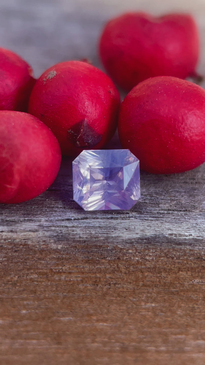 360-degree video of a 1.04 carat opalescent pink to purple sapphire, cushion cut, highlighting its natural untreated clarity and Sri Lankan origin.