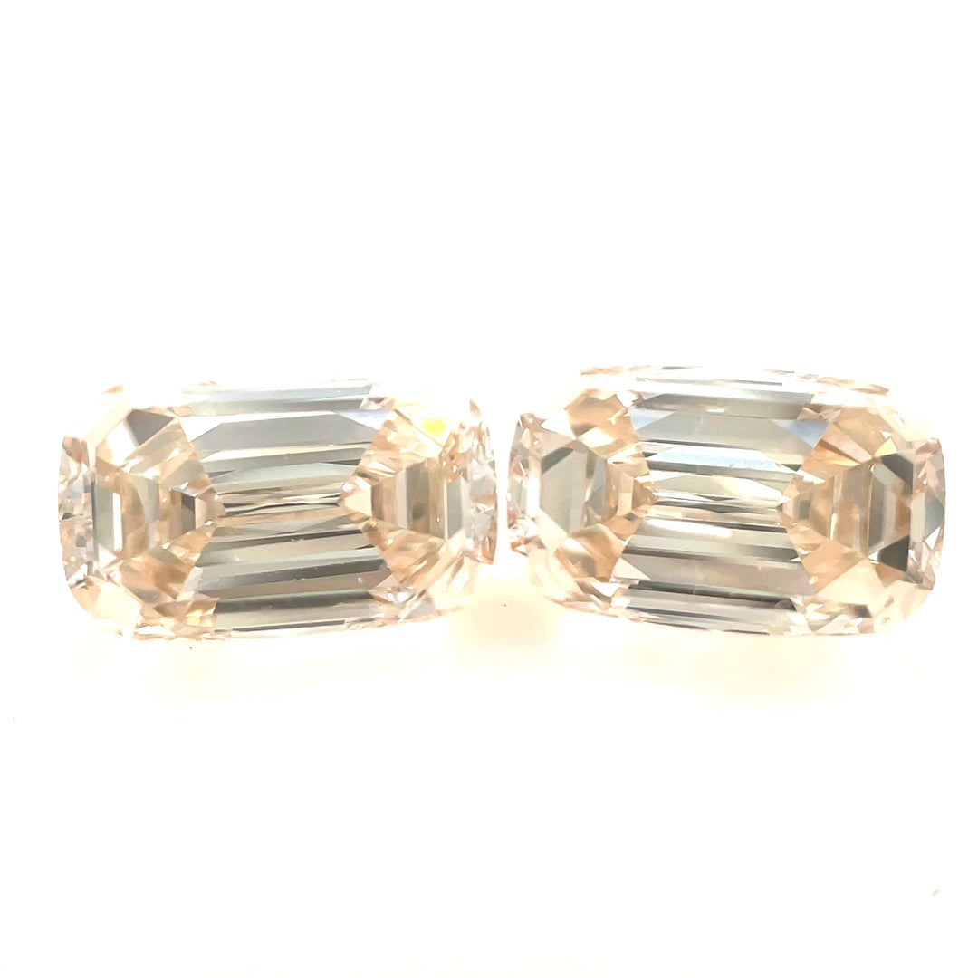A stunning 2.05-carat pair of antique-style elongated step-cut cushion diamonds with a champagne light fancy yellowish-brown hue. Showcasing their brilliance and clarity (SI1 & VS2) under different lighting conditions, these ethically sourced diamonds from South Africa make a perfect matched set for fine jewelry.
