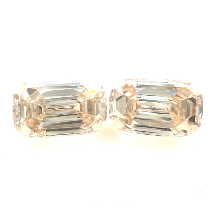 A stunning 2.05-carat pair of antique-style elongated step-cut cushion diamonds with a champagne light fancy yellowish-brown hue. Showcasing their brilliance and clarity (SI1 & VS2) under different lighting conditions, these ethically sourced diamonds from South Africa make a perfect matched set for fine jewelry.