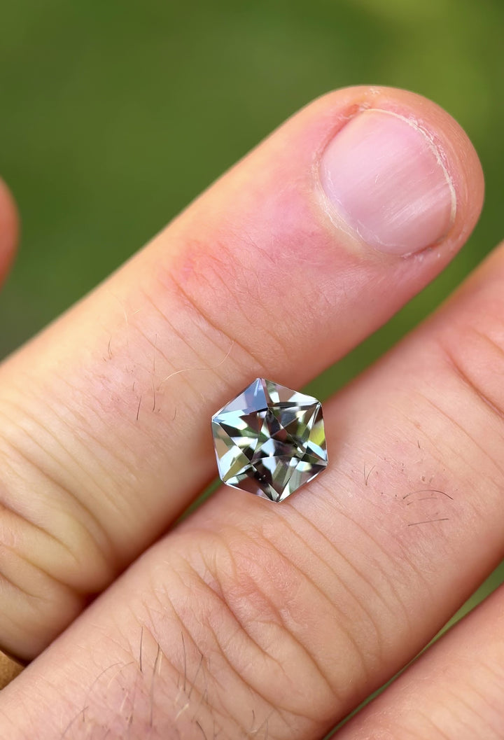 Video of 3.32ct Tanzanite resting on a hand in natural light, rotating to reveal a vibrant mix of lavender, teal, and blue hues from Merelani Hills.