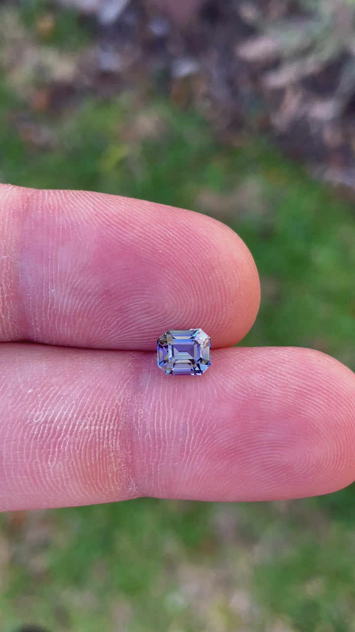 Detailed Video of a Custom Modified Emerald Cut Tanzanite Gemstone in Teal, Blue, Green, and Purple Colors, Weighing 1.32 Carats, with Dimensions 6.49 x 5.58 x 4.60 mm, from Merelani Hills, Arusha Region, Tanzania - No Treatment