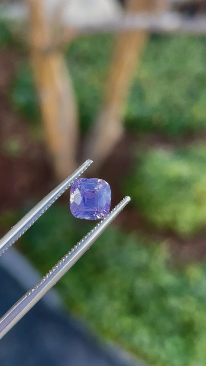 360-degree video showcasing a 1.53 carat cushion cut sapphire gemstone with opalescent pink to purple hues, untreated, and from Sri Lanka.