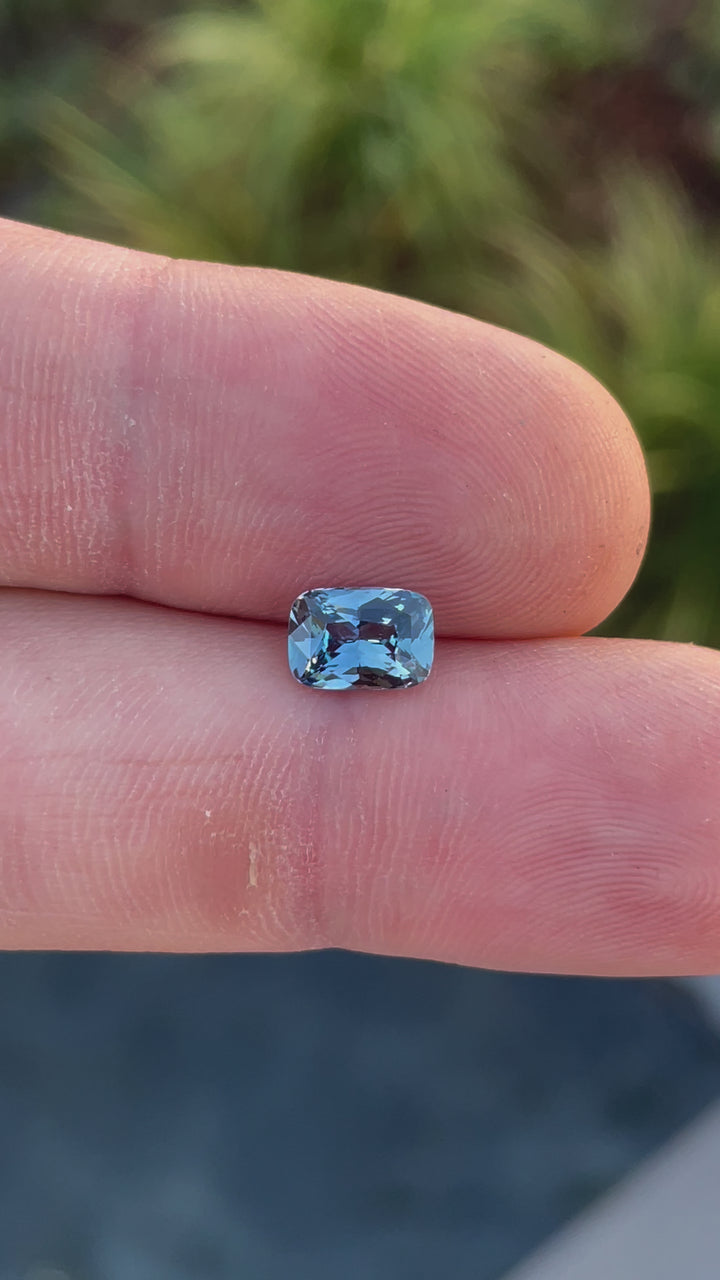 A video showcasing the vivid denim blue and green hues of the sapphire under natural light, emphasizing its heated treatment.