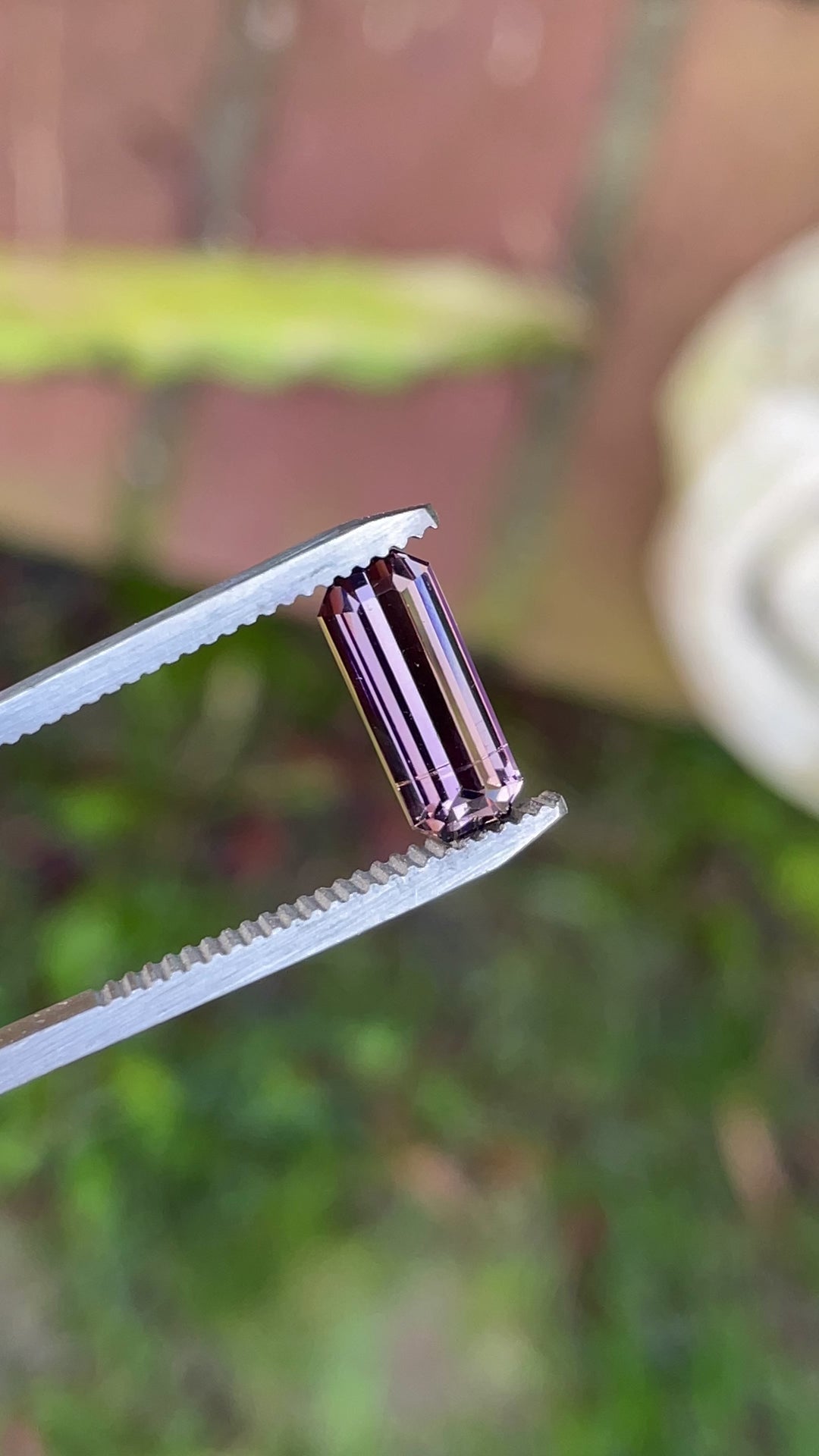360° video showcasing a 2.12-carat Tanzanite gemstone with color shifts from lavender to peach and pink in a precision emerald cut.