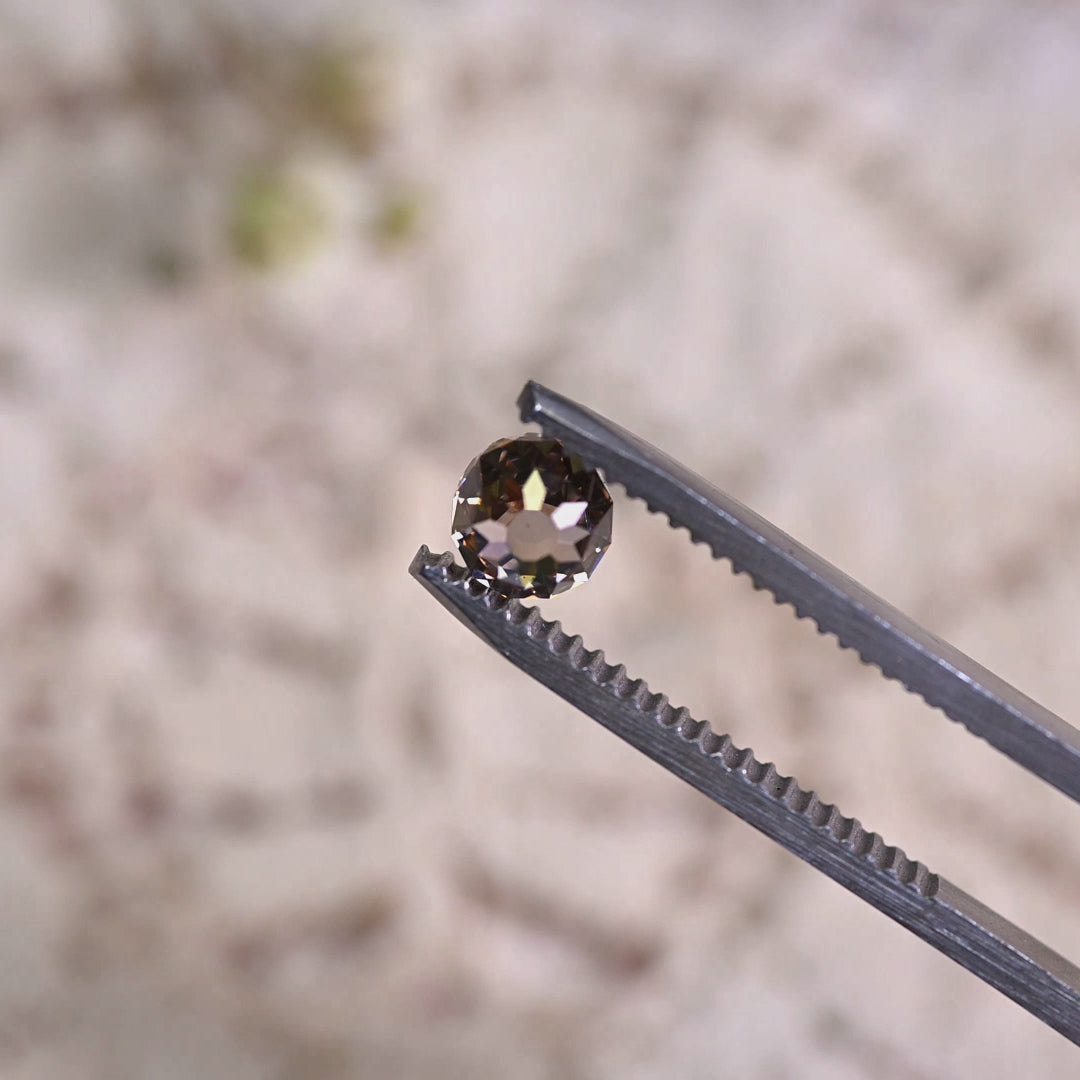 Loose fancy brown Mughal cut diamond turning in light, revealing its faceted dome structure and natural color from South Africa.