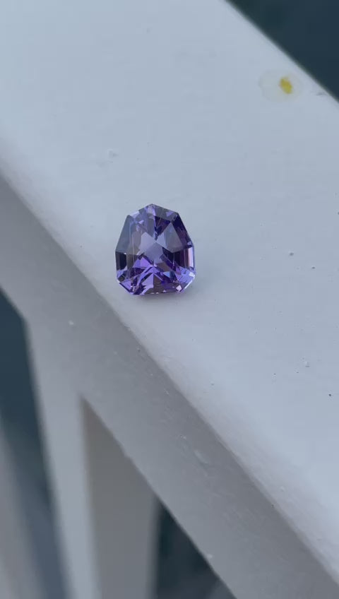 Video showcasing a 3.19-carat Tanzanite with a custom geometric shield cut, displaying a dynamic range of blue, purple, and lavender colors under various lighting conditions.