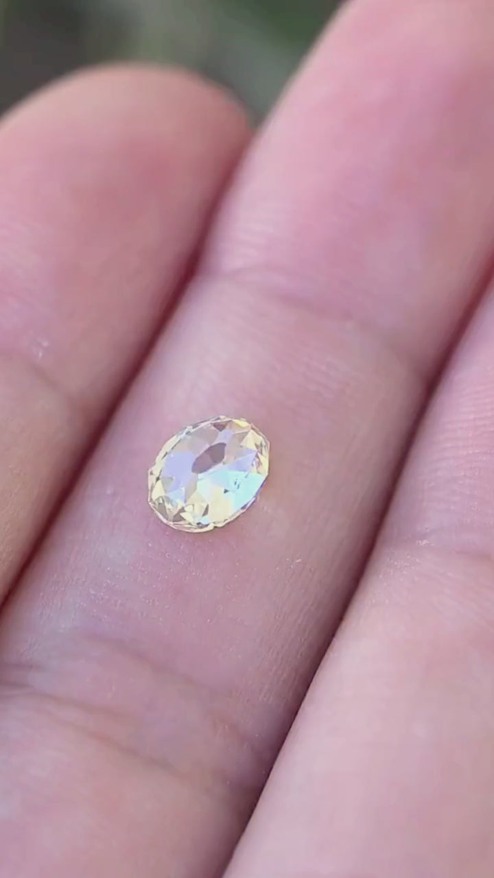 1.09 carat oval Mughal cut South African diamond shown in motion on a hand, revealing its scale and changing champagne, ivory and silvery reflections.