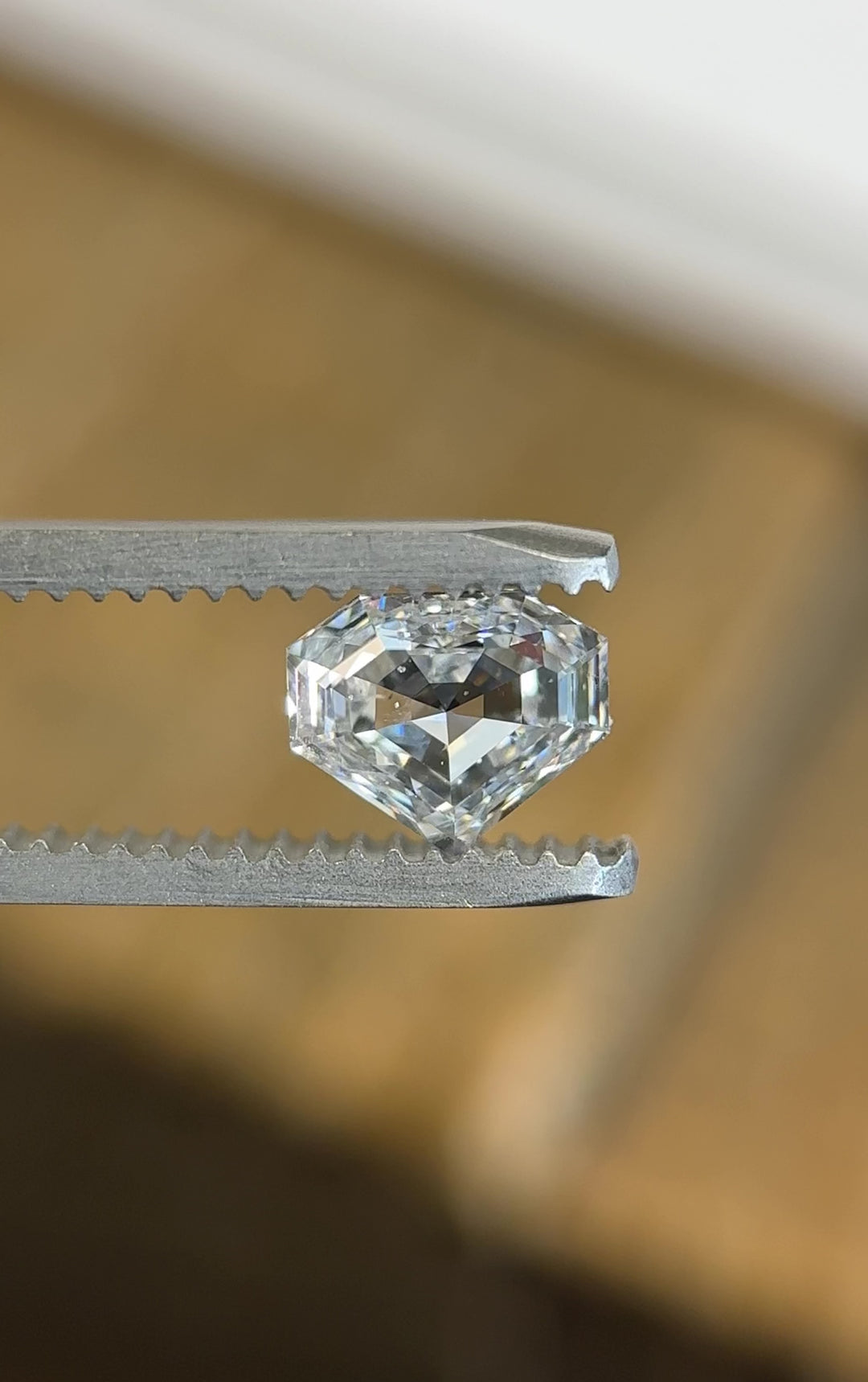 Video of a 1.01 carat E color SI1 clarity diamond from Gahcho Kué, Canada, rotating in tweezers to show brilliance, clarity, and the precision of its shield step cut. Natural, untreated, and ethically sourced.