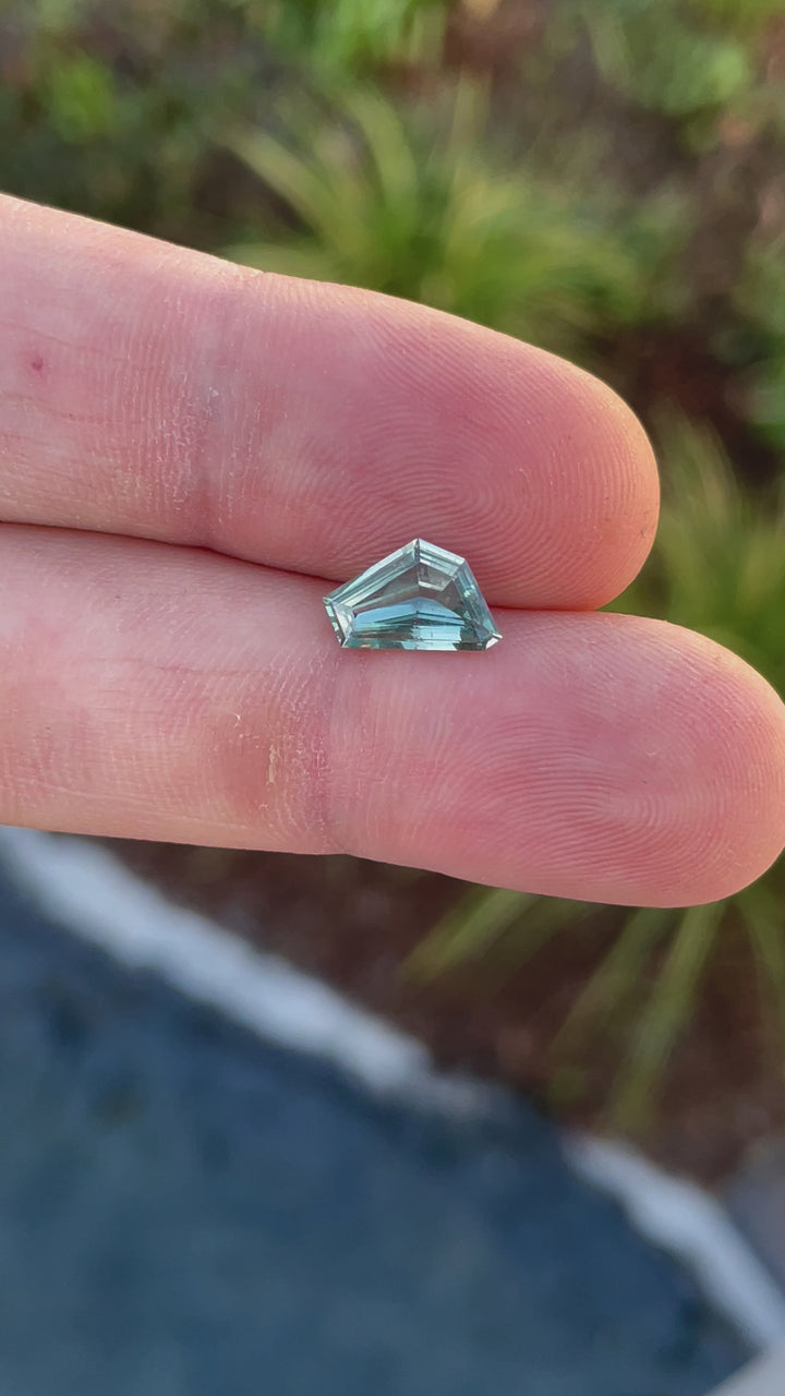 Video of a natural 2.00-carat blue-green sapphire in a unique geometric freeform cut, highlighting its brilliance.