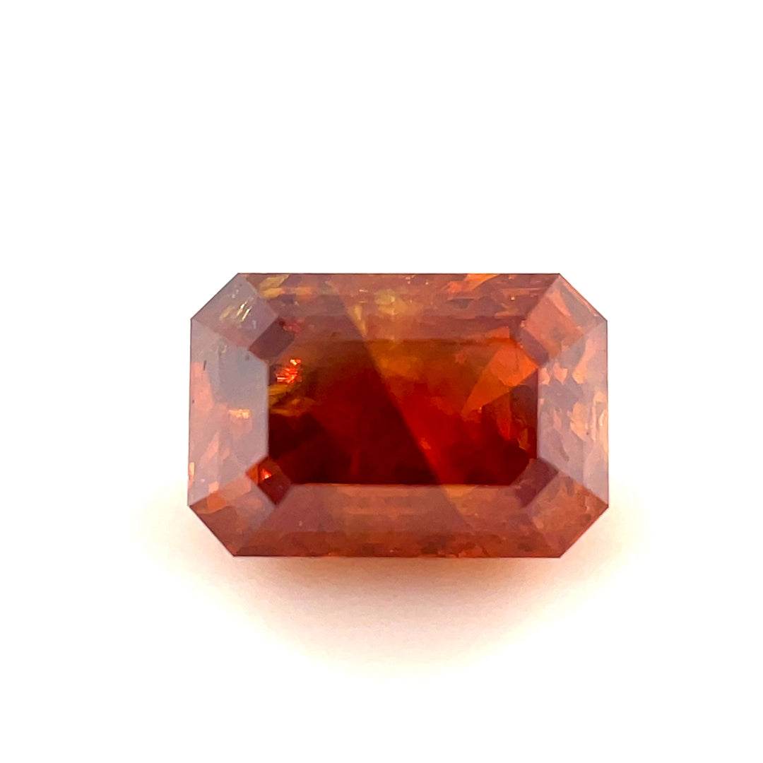 A breathtaking 1.02-carat emerald step-cut diamond in a deep brown-orange cognac hue. This video showcases its natural beauty and precision cut from various angles.