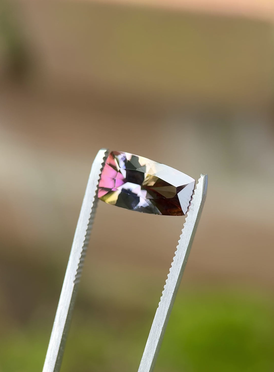 Rotating video of 4.35ct untreated Tanzanite from Tanzania showing strong yellow, teal, lavender, and red color play in cushion cut