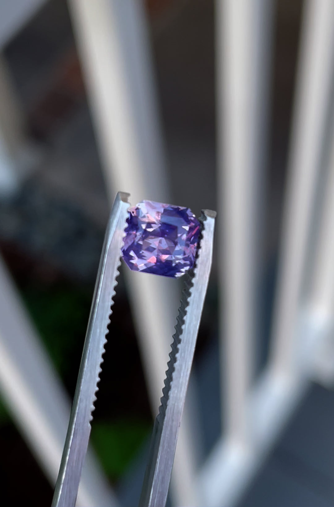 See the captivating interplay of colors in this 1.57-carat opalescent sapphire. The custom radiant cut highlights its pink and purple tones, making it a stunning gemstone from Sri Lanka, untreated and ethically sourced.