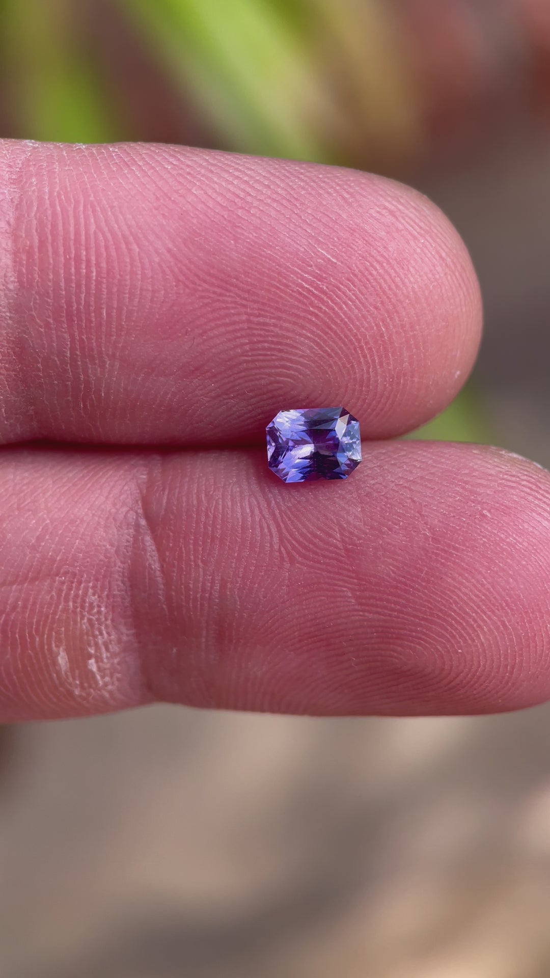 Detailed video highlighting the unique features of a 1.05 carat radiant cut sapphire, with captivating pink and purple tones, sourced from Sri Lanka and untreated.