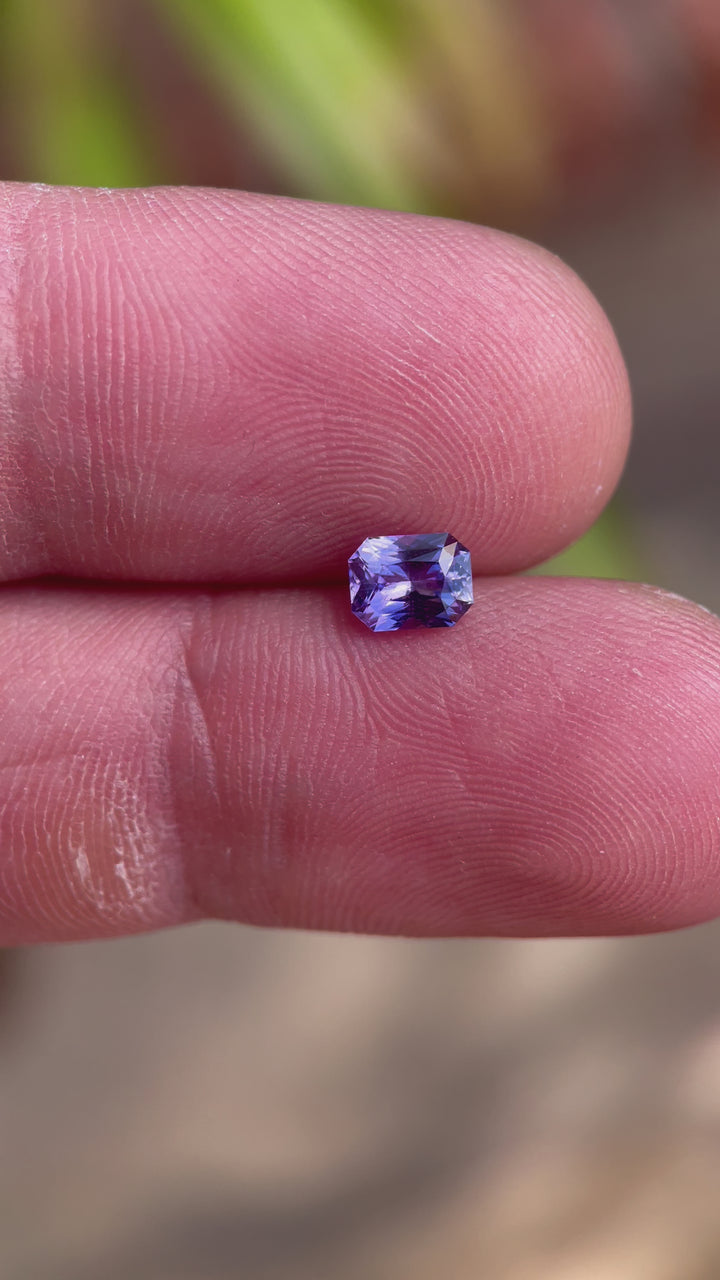Detailed video highlighting the unique features of a 1.05 carat radiant cut sapphire, with captivating pink and purple tones, sourced from Sri Lanka and untreated.