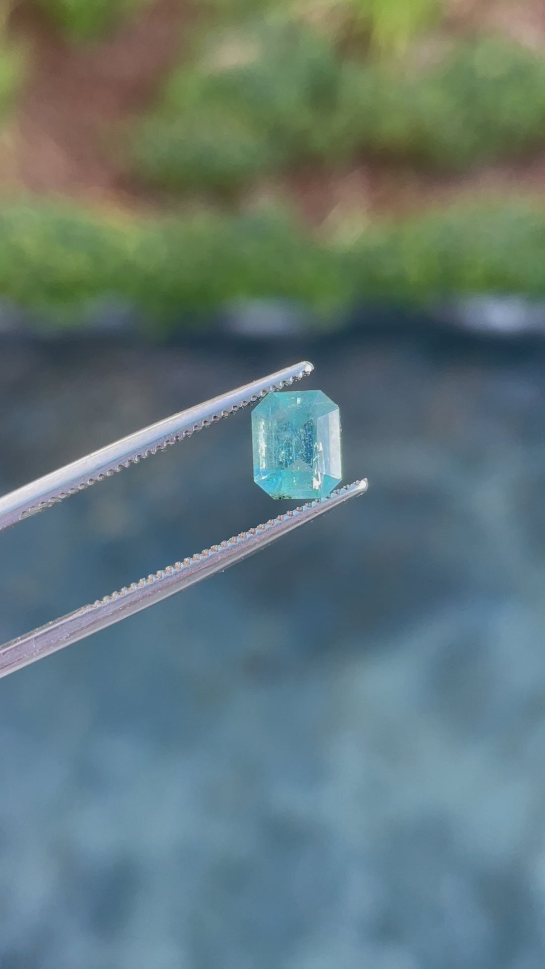 360-degree view of a 1.17-carat emerald cut gemstone with vibrant green-blue tones, sourced from Nasarawa, Nigeria