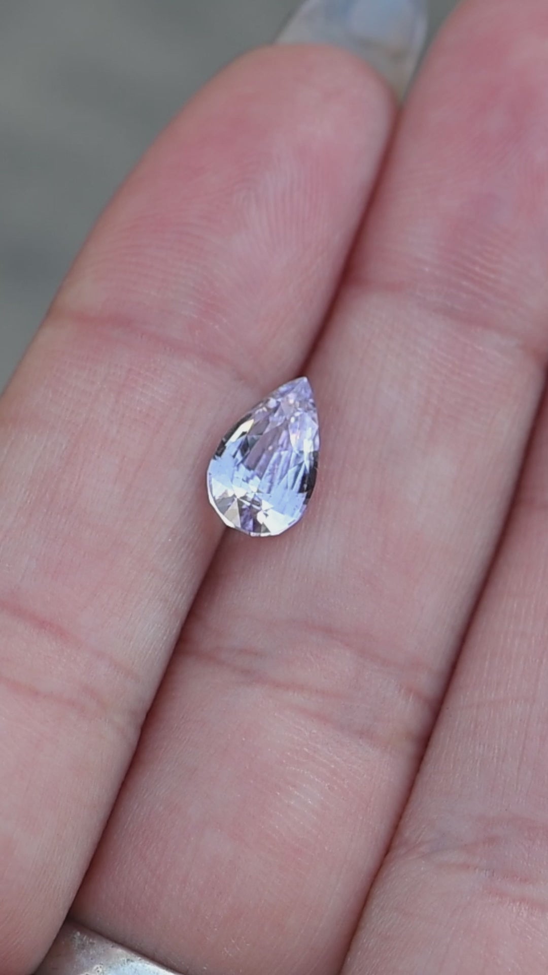 2.06ct natural lavender purple pink sapphire pear cut shown in hand for engagement ring