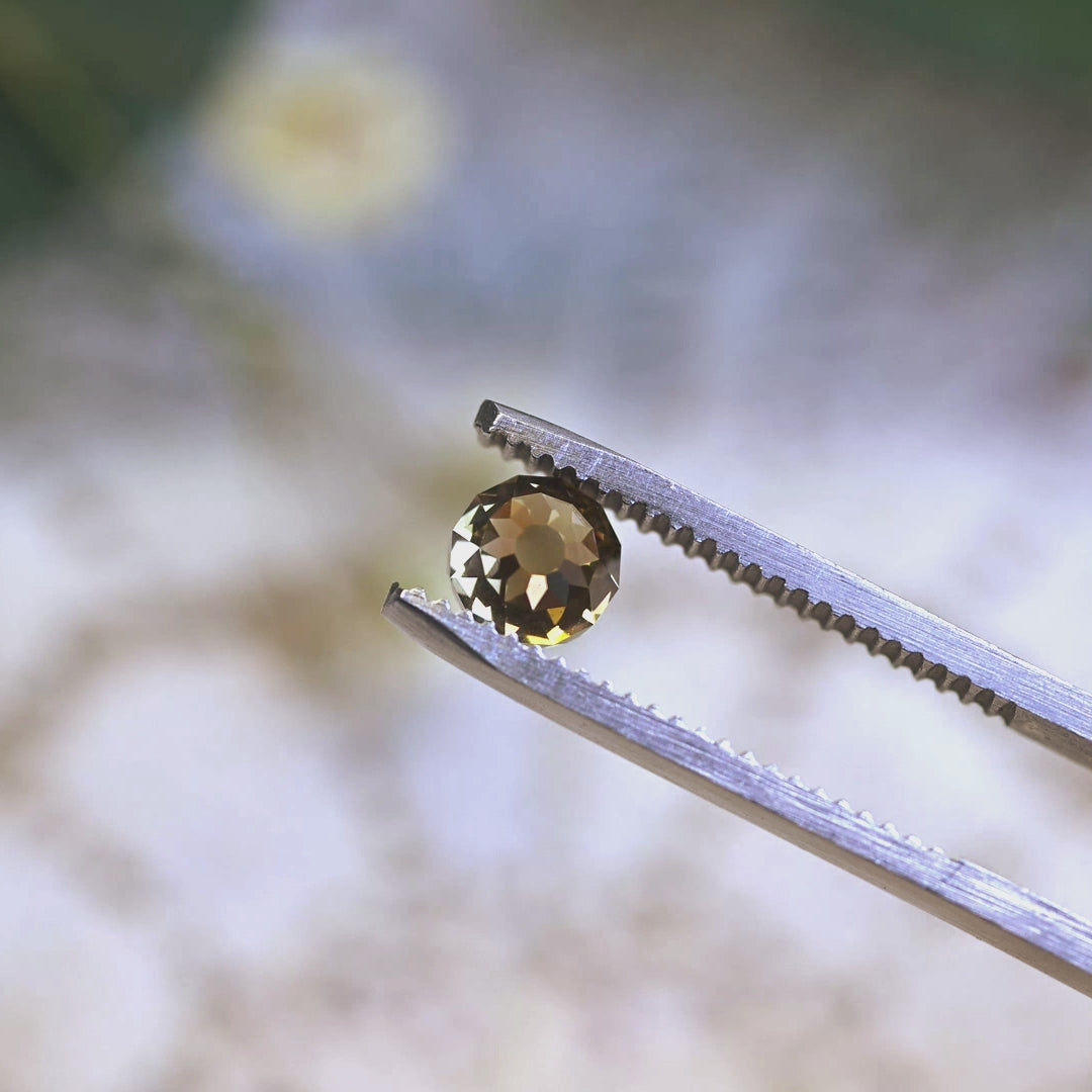 Loose fancy yellow brown Mughal cut diamond turning in light, highlighting the historic faceted dome and natural color from South Africa.