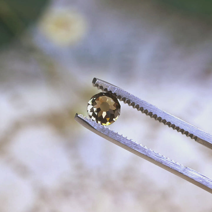 Loose fancy yellow brown Mughal cut diamond turning in light, highlighting the historic faceted dome and natural color from South Africa.