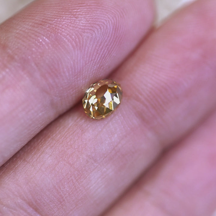 Loose 1.12 carat champagne Mughal cut diamond from South Africa turning in light, revealing the golden-brown tone and soft internal brilliance.