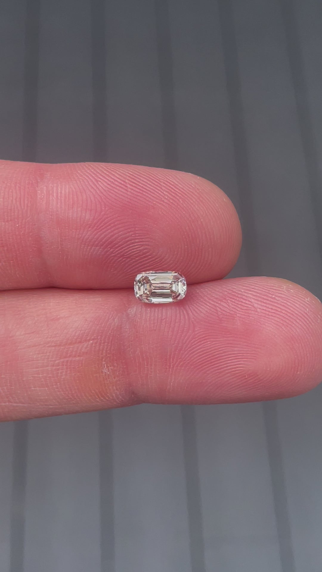 Detailed view of a 1.03-carat VS2 clarity diamond with a fancy yellowish brown color, emphasizing its antique-inspired elongated step cut and South African origin.