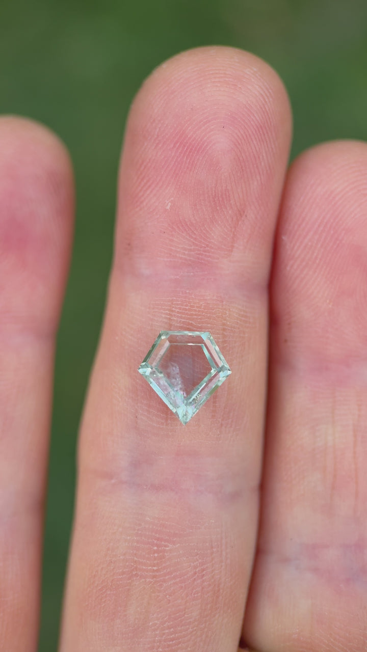 Rotating video of 2.81ct heated Montana sapphire with shield portrait cut and seafoam green color shift