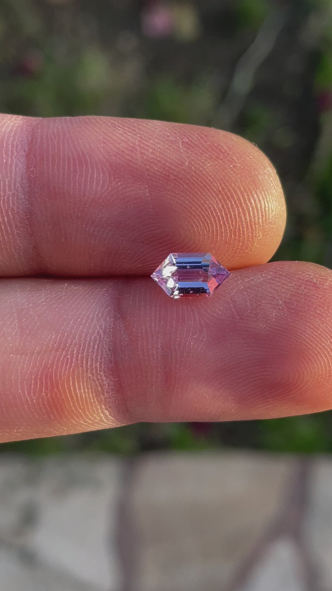 A detailed view of the 1.33-carat step cut hexagon sapphire, highlighting its natural beauty and high clarity in different lighting conditions.